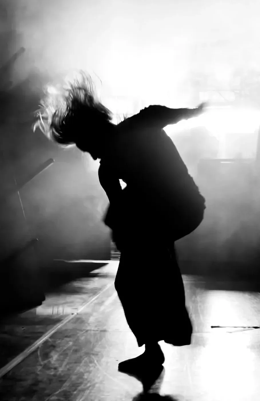 A dancer mid-movement in stage light